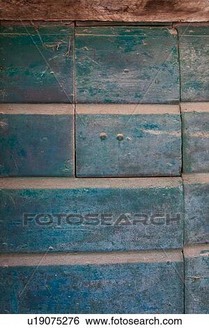 Stock Photograph - Detail of very old, turquoise painted wooden plank door with spy hole, medieval town, Umbria, Italy. Fotosearch