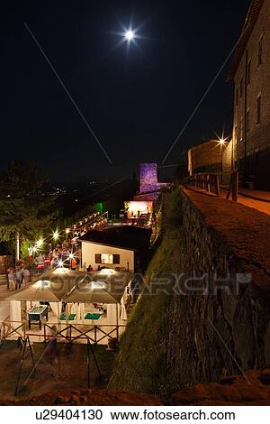 Full moon creating a star over a crowded ourdoor cafe below the medieval stone walls of hilltop Montecastello di Vibio, with the Tiber valley in the darkness beyond, Umbria, Italy View Large Photo Image Stock Image - Full moon creating a star over a crowded ourdoor cafe below the medieval stone walls of hilltop Montecastello di Vibio, with the Tiber valley in the darkness beyond, Umbria, Italy. Fotosearch