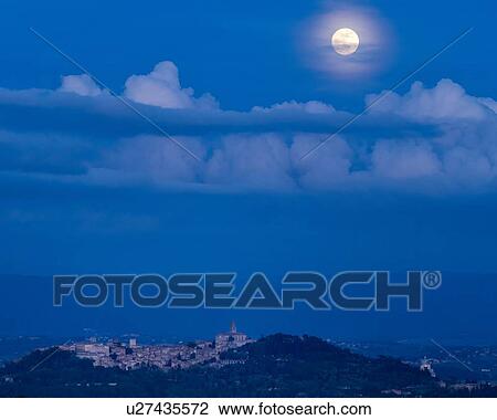 Full moon rising over hilltop town of Todi in blue twilight with gentle clouds over Tiber valley, hills beyond, Umbria, Italy View Large Photo Image Stock Image - Full moon rising over hilltop town of Todi in blue twilight with gentle clouds over Tiber valley, hills beyond, Umbria, Italy. Fotosearch