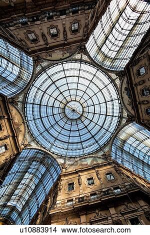 Picture - Gallerica Vittorio Emanuele: detail view of central mall area ceiling, glass and cast iron arched roof and central dome with stone carving decoration, Milan Italy. Fotosearch