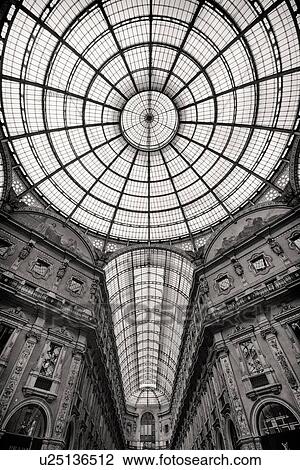 Stock Image - Gallerica Vittorio Emanuele: detail monochrome view of glass and cast iron central vaulted dome and arched roof, Milan Italy. Fotosearch