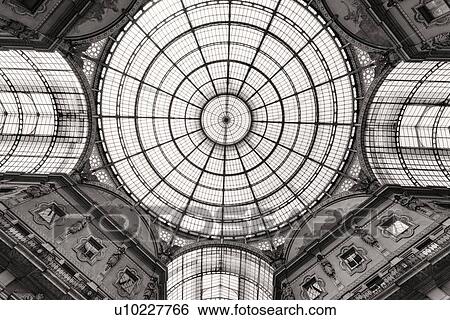 Stock Photograph - Gallerica Vittorio Emanuele: detail monochrome view of glass and cast iron central vaulted dome and arched roof, Milan Italy. Fotosearch