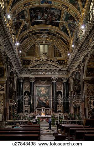 Genoa Centro Storico: Church of San Gesu central nave leading to richly decorated altar, frescoed ceiling and lavish Baroque decoration, Genova, Italy View Large Photo Image Stock Photo - Genoa Centro Storico: Church of San Gesu central nave leading to richly decorated altar, frescoed ceiling and lavish Baroque decoration, Genova, Italy. Fotosearch