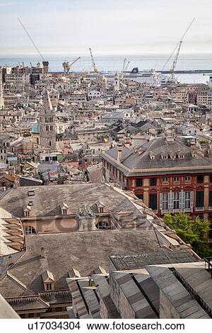 Picture - Genoa Spianato Castelletto: view overlooking the city to the port area with ships docked, gentle afternoon sunlight, Genova, Italy. Fotosearch