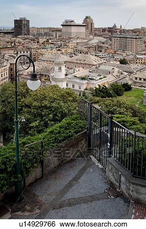 Stock Photograph - Genoa Spianato Castelletto: view overlooking the city to the port area with ships docked, gentle afternoon sunlight, Genova, Italy. Fotosearch