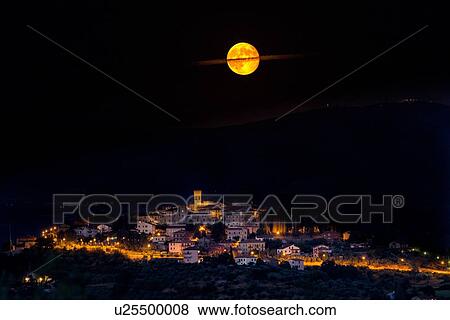 Golden full moon with cloud ring over medieval hilltop town of MonteCastello di Vibio with night lights and hills beyond, Umbria, Italy View Large Photo Image Stock Photo - Golden full moon with cloud ring over medieval hilltop town of MonteCastello di Vibio with night lights and hills beyond, Umbria, Italy. Fotosearch