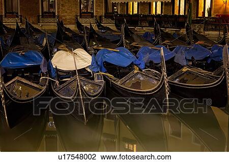 Gondoliers moored at night: detail of pattern of boats alongside each other in Orseolo Basin, with reflections, near San Marco, Venice, Italy View Large Photo Image Stock Image - Gondoliers moored at night: detail of pattern of boats alongside each other in Orseolo Basin, with reflections, near San Marco, Venice, Italy. Fotosearch