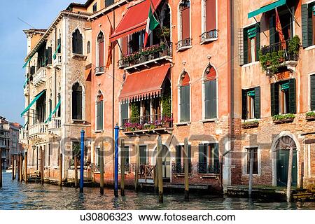 Grand Canal, detail of ornately decorated palazzi, brightly coloured poles for mooring gondolas, late afternoon golden light, Venice, Italy View Large Photo Image Stock Image - Grand Canal, detail of ornately decorated palazzi, brightly coloured poles for mooring gondolas, late afternoon golden light, Venice, Italy. Fotosearch