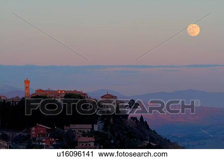 Hilltop medieval town of MonteCastello di Vibio with full moon rising above church and campanile, hills beyond, Umbria, Italy View Large Photo Image Stock Image - Hilltop medieval town of MonteCastello di Vibio with full moon rising above church and campanile, hills beyond, Umbria, Italy. Fotosearch