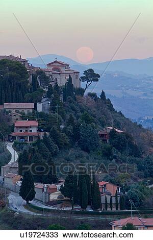Hilltop medieval town of MonteCastello di Vibio with full moon rising above church and campanile, hills beyond, Umbria, Italy View Large Photo Image Stock Image - Hilltop medieval town of MonteCastello di Vibio with full moon rising above church and campanile, hills beyond, Umbria, Italy. Fotosearch