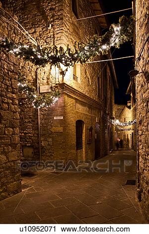 Medieval hilltop town of MonteCastello di Vibio: street at night, with night lights, and Christmas garlands strung between the old stone houses, Umbria, Italy View Large Photo Image Stock Image - Medieval hilltop town of MonteCastello di Vibio: street at night, with night lights, and Christmas garlands strung between the old stone houses, Umbria, Italy. Fotosearch
