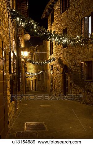 Medieval hilltop town of MonteCastello di Vibio: street at night, with night lights, and Christmas garlands strung between the old stone houses, Umbria, Italy View Large Photo Image Stock Photo - Medieval hilltop town of MonteCastello di Vibio: street at night, with night lights, and Christmas garlands strung between the old stone houses, Umbria, Italy. Fotosearch