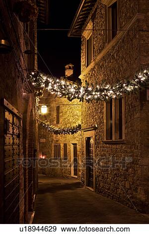 Medieval hilltop town of MonteCastello di Vibio: street at night, with night lights, and Christmas garlands strung between the old stone houses, Umbria, Italy View Large Photo Image Stock Photo - Medieval hilltop town of MonteCastello di Vibio: street at night, with night lights, and Christmas garlands strung between the old stone houses, Umbria, Italy. Fotosearch