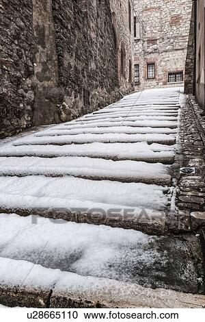 Medieval street - stone house and stairway entrance, covered with snow in early dawn light, desaturated view, MonteCastello di Vibio, Umbria, Italy View Large Photo Image Stock Image - Medieval street - stone house and stairway entrance, covered with snow in early dawn light, desaturated view, MonteCastello di Vibio, Umbria, Italy. Fotosearch