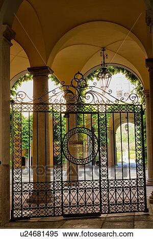 Milan Fashion District: palazzo entranceway with stucco arched ceilings, beautiful wrought iron gate and attractive courtyard beyond, Milan, Italy View Large Photo Image Stock Photography - Milan Fashion District: palazzo entranceway with stucco arched ceilings, beautiful wrought iron gate and attractive courtyard beyond, Milan, Italy. Fotosearch