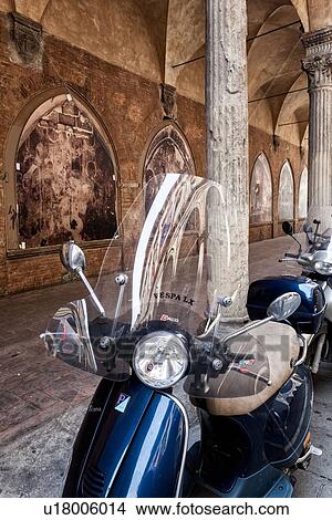Motorbikes parked alongside Renaissance portico of S. Giacamo Maggiore with arched frescoed panels under decorated stone Corinthian columns, detail with refelction of Palazzo opposite, Bologna, Italy View Large Photo Image Picture - Motorbikes parked alongside Renaissance portico of S. Giacamo Maggiore with arched frescoed panels under decorated stone Corinthian columns, detail with refelction of Palazzo opposite, Bologna, Italy. Fotosearch