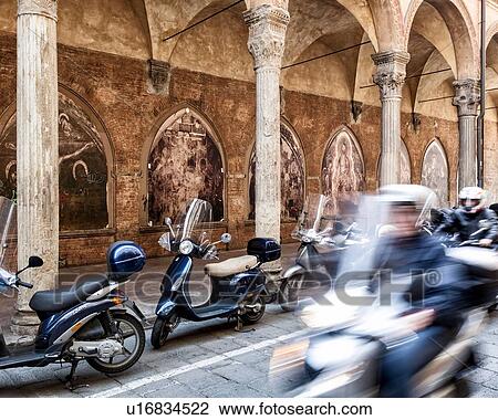 Motorbikes parked alongside Renaissance portico of S. Giacamo Maggiore with arched frescoed panels under decorated stone Corinthian columns, motorbike motion blur in foreground, Bologna, Italy View Large Photo Image Stock Image - Motorbikes parked alongside Renaissance portico of S. Giacamo Maggiore with arched frescoed panels under decorated stone Corinthian columns, motorbike motion blur in foreground, Bologna, Italy. Fotosearch