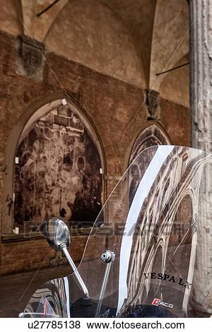 Stock Photo - Motorbikes parked alongside Renaissance portico of S. Giacamo Maggiore with arched frescoed panels under decorated stone Corinthian columns, detail with refelction of Palazzo opposite, Bologna, Italy. Fotosearch