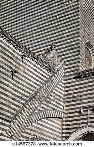 Stock Photo - Orvieto Duomo - detail of side wall with black and white striped stone, curved walls and decorations causing dramatic patterned effect, Romanesque-Gothic style, Umbria, Italy. Fotosearch