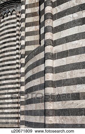 Stock Photo - Orvieto Duomo - detail of side wall with black and white striped stone, curved walls and decorations causing dramatic patterned effect, Romanesque-Gothic style, Umbria, Italy. Fotosearch