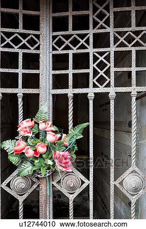 Red roses tied to metal wrought iron gate at cemetery, detail view, Monterosso al Mare, Cinque Terre, Liguria, Italy View Large Photo Image Stock Image - Red roses tied to metal wrought iron gate at cemetery, detail view, Monterosso al Mare, Cinque Terre, Liguria, Italy. Fotosearch
