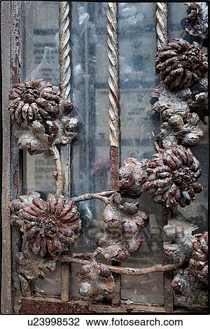 Rusting metal floral decorations of metal-glass door - tomb entrance. Monterosso al Mare, Cinque Terre, Liguria, Italy View Large Photo Image Stock Image - Rusting metal floral decorations of metal-glass door - tomb entrance. Monterosso al Mare, Cinque Terre, Liguria, Italy. Fotosearch