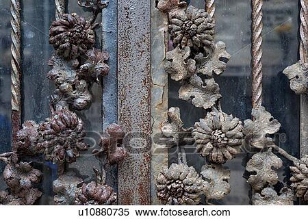 Stock Photography - Rusting metal floral decorations of metal-glass door - tomb entrance. Monterosso al Mare, Cinque Terre, Liguria, Italy. Fotosearch