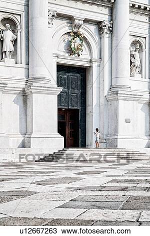 San Giorgio Maggiore, detail of facade, and white and stone paved piazza, lone woman in front of church doorway, Venice, Italy View Large Photo Image Stock Image - San Giorgio Maggiore, detail of facade, and white and stone paved piazza, lone woman in front of church doorway, Venice, Italy. Fotosearch
