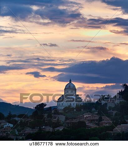 Stock Photo - Santa Maria della Consolazione (Tempio) view at sunset with dramatic grey yellow clouds, Todi, Umbria, Italy. Fotosearch