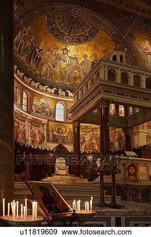 Stock Photo - Santa Maria in Trastevere: interior detail of apse completely decorated with 13th century Cavallini mosaics, with baldacchino altar, and richly decorated gilt coffered ceiling, Rome, Italy. Fotosearch
