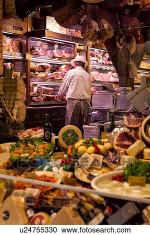 Shop window full of cheeses and meat with grocer wearing apron and white hat, back view, as he works, Bologna, Italy View Large Photo Image Stock Image - Shop window full of cheeses and meat with grocer wearing apron and white hat, back view, as he works, Bologna, Italy. Fotosearch