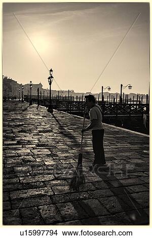 Street sweeper at dawn: Molo San Marco and Riva beyond, with row of traditional wrought iron lamps in the sunlight, Venice, Italy View Large Photo Image Picture - Street sweeper at dawn: Molo San Marco and Riva beyond, with row of traditional wrought iron lamps in the sunlight, Venice, Italy. Fotosearch