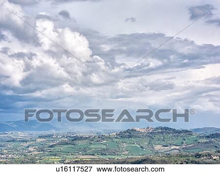 Sunny afternoon view of Todi hilltop town in Tiber Valley with dramatic cloud formation, MonteCastello di Vibio, Umbria, Italy View Large Photo Image Stock Photo - Sunny afternoon view of Todi hilltop town in Tiber Valley with dramatic cloud formation, MonteCastello di Vibio, Umbria, Italy. Fotosearch