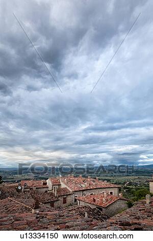 Terrace view over red tiled rooftops to Tiber valley and hills beyond, with dramatic storm clouds gathering overhead, Montecastello di Vibio, Umbria, Italy View Large Photo Image Stock Image - Terrace view over red tiled rooftops to Tiber valley and hills beyond, with dramatic storm clouds gathering overhead, Montecastello di Vibio, Umbria, Italy. Fotosearch