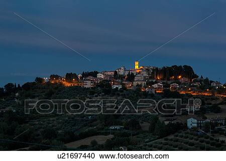 Twilight view of medieval hilltop town of MonteCastello di Vibio. stone houses and belltower, olive groves on slope below, with pink and blue twilight sky, Umbria, Italy View Large Photo Image Stock Image - Twilight view of medieval hilltop town of MonteCastello di Vibio. stone houses and belltower, olive groves on slope below, with pink and blue twilight sky, Umbria, Italy. Fotosearch