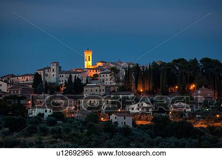 Twilight view of medieval hilltop town of MonteCastello di Vibio. stone houses and belltower, olive groves on slope below, with pink and blue twilight sky, Umbria, Italy View Large Photo Image Stock Photography - Twilight view of medieval hilltop town of MonteCastello di Vibio. stone houses and belltower, olive groves on slope below, with pink and blue twilight sky, Umbria, Italy. Fotosearch