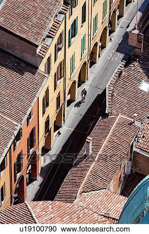 View from Torre Asinelli of Bologna looking over the red-tiled roofs of the city, and portico of Via San Vitale with single cyclist, Bologna, Italy View Large Photo Image Stock Image - View from Torre Asinelli of Bologna looking over the red-tiled roofs of the city, and portico of Via San Vitale with single cyclist, Bologna, Italy. Fotosearch
