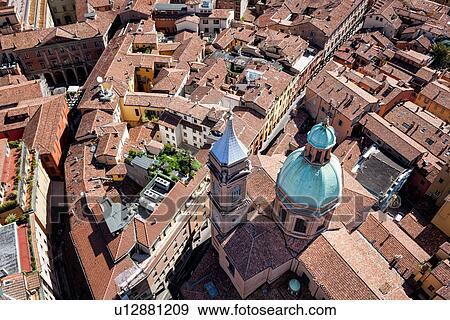 View from Torre Asinelli of Bologna looking over church of San Bartolomeo e Gaetano with green dome and bell-tower, to the red-tiled roofs of the city, Bologna, Italy View Large Photo Image Stock Photo - View from Torre Asinelli of Bologna looking over church of San Bartolomeo e Gaetano with green dome and bell-tower, to the red-tiled roofs of the city, Bologna, Italy. Fotosearch