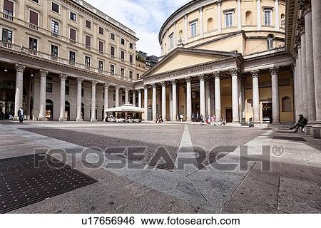 Stock Photograph - View of cobbled piazza and San Carlo in Corso church facade, rotonda neo-Classic style with columned portico, Milan Italy. Fotosearch