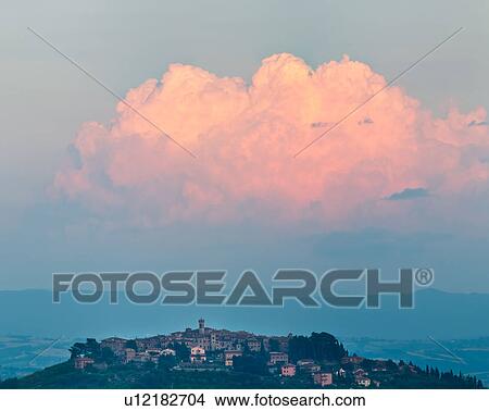 View of medieval hilltop town of MonteCastello di Vibio, sunset with pink billowing cumulus clouds, and Tiber valley beyond, Umbria, Italy View Large Photo Image Picture - View of medieval hilltop town of MonteCastello di Vibio, sunset with pink billowing cumulus clouds, and Tiber valley beyond, Umbria, Italy. Fotosearch