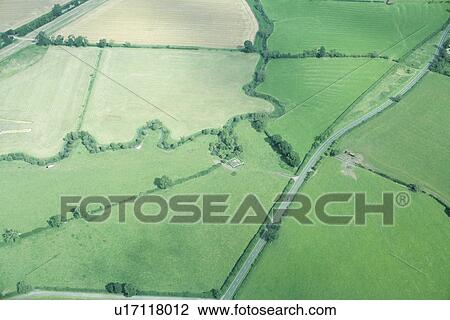 Stock Image - Aerial view of rural fields and road. Fotosearch