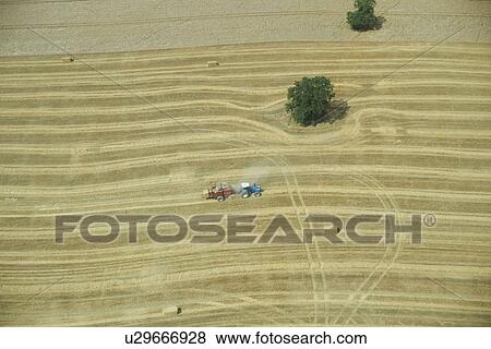 Stock Photo - Aerial view of tractor in crop field. Fotosearch