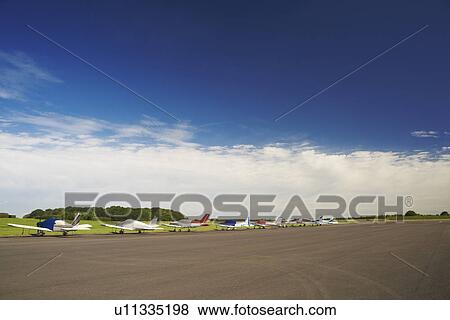 Stock Photo - Airplanes parked on airstrip. Fotosearch