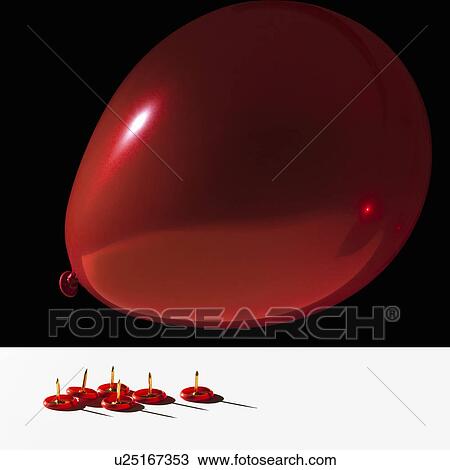 Stock Image - Balloon hovering over sharp pins. Fotosearch