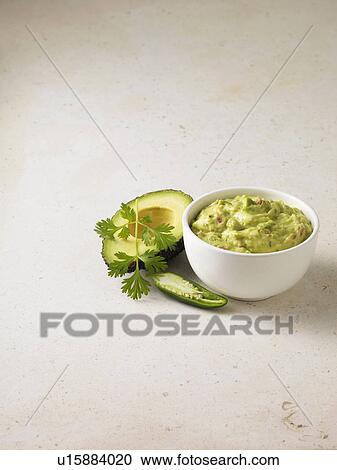 Stock Image - Bowl of guacamole with avocado. Fotosearch