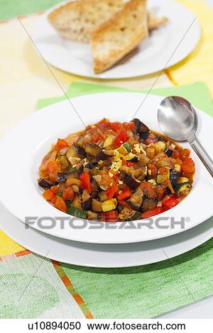 Stock Image - Bowl of ratatouille with bread. Fotosearch