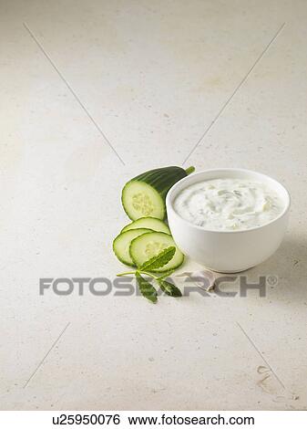 Stock Photograph - Bowl of tzatziki with cucumber. Fotosearch