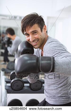 Boxer wearing boxing gloves in gym View Large Photo Image Picture - Boxer wearing boxing gloves in gym. Fotosearch