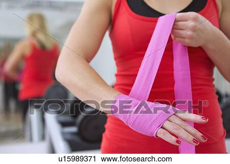 Boxer wrapping her hands in gym View Large Photo Image Stock Image - Boxer wrapping her hands in gym. Fotosearch