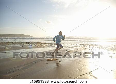 Boy running on beach View Large Photo Image Stock Image - Boy running on beach. Fotosearch